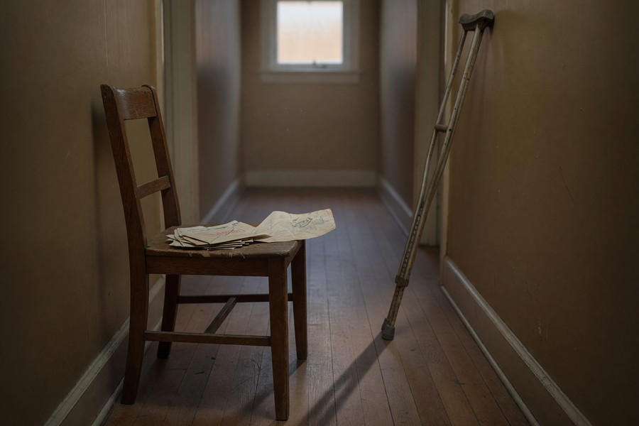 Remote worker reviewing health and disability insurance documents at a home office desk