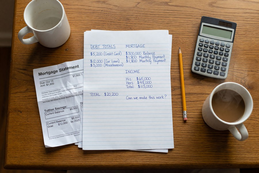 Freelance family reviewing life insurance policy documents with financial advisor at home